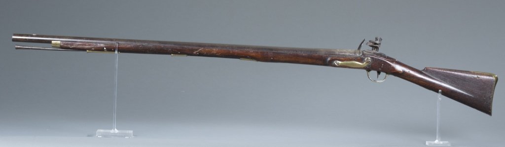 Revolutionary War-era British "Brown Bess" Musket: Revolutionary War-era British "Brown Bess" Musket. Lockplate stamped "TOWER" and British crown over "GR." British arsenal proof marks on barrel. Butt plate may be replacement. Measures 55" overall len