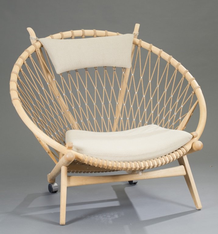 Hans Wegner Circle Chair: Solid oak with woven flag line. Natural color cushion, Label on rim. 37 1/2" H x 43 1/2" W x 33" D