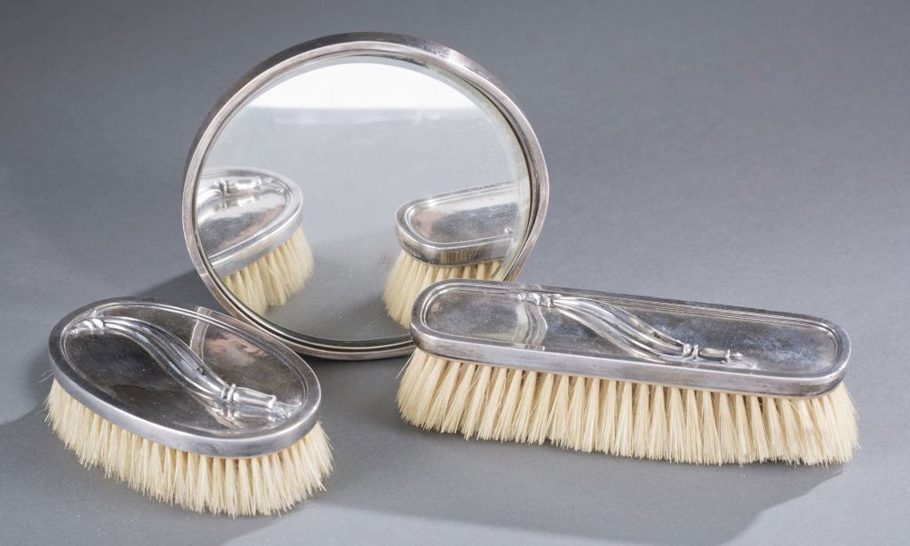 Three Piece Georg Jensen Dresser Set: Georg Jensen and Wendel A/S. Includes: one (1) hand mirror, two (2) brushes. Marked 925 Danish sterling, HN 236. Made between 1945-1951.