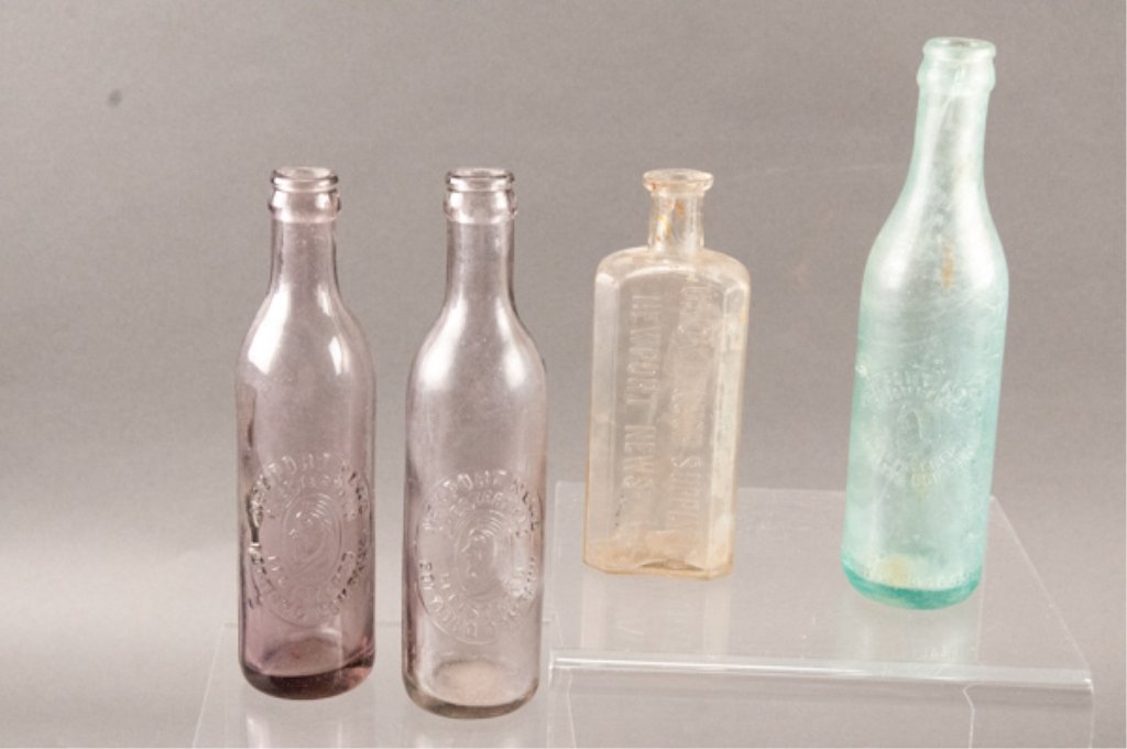 Four Glass Bottles from Newport News, Virginia: Including two lilac bottles, one Union Liquor Supply Co. and one blue/green bottle.