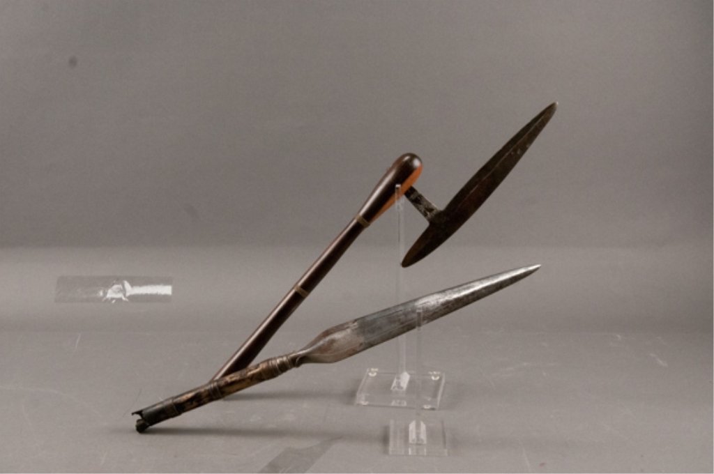 Two(2) African Weapons: Spear tip and ax type weapon. Rust to both. Spear has remnant of broken shaft. Spear: 13"L