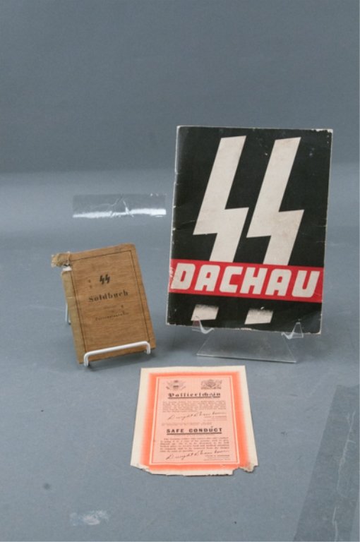 Lot WWII Ephemera: SS Soldbuch for a member of the 17 Battalion SS Panzer Grenidairs. Oct. 1, 1944 dated. Possible bullet damage in upper left corner, otherwise minor wear. Also includes post war book by US Army on SS i