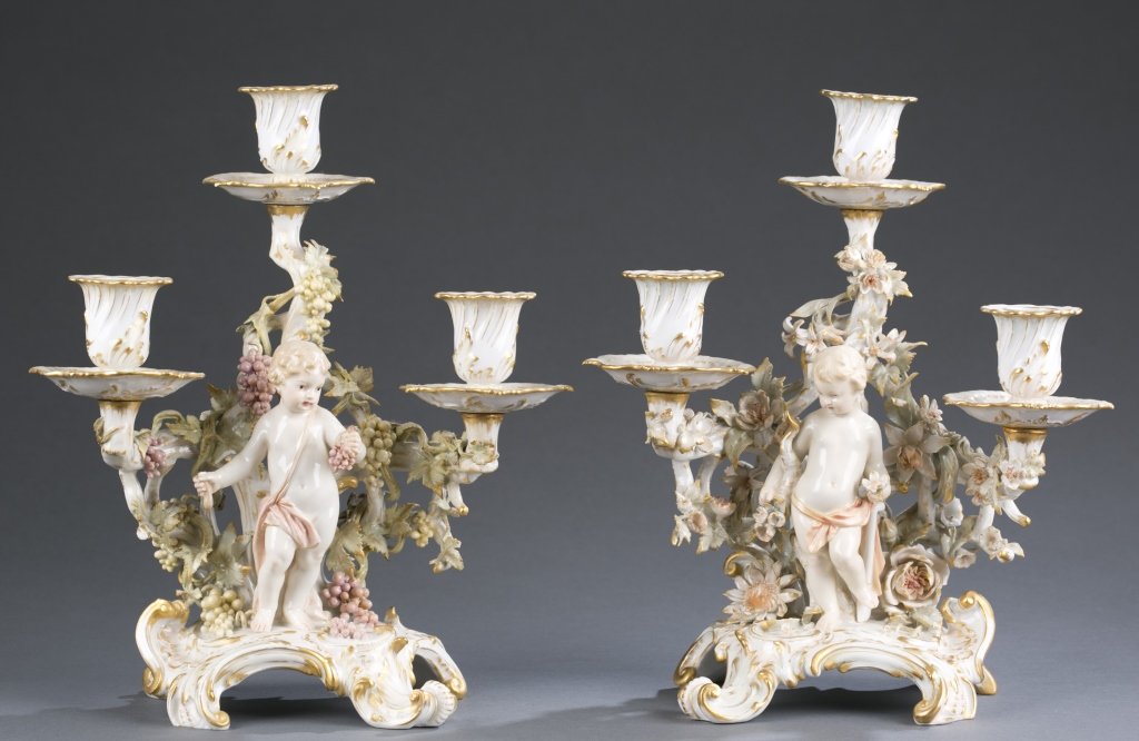 Pair of German KPM Porcelain Candelabra: Three arms with central cherub figure. One adorned with delicate red and white grapes; other surrounded by flowers. Blue mark in underglaze with red KPM stamp. 11" H