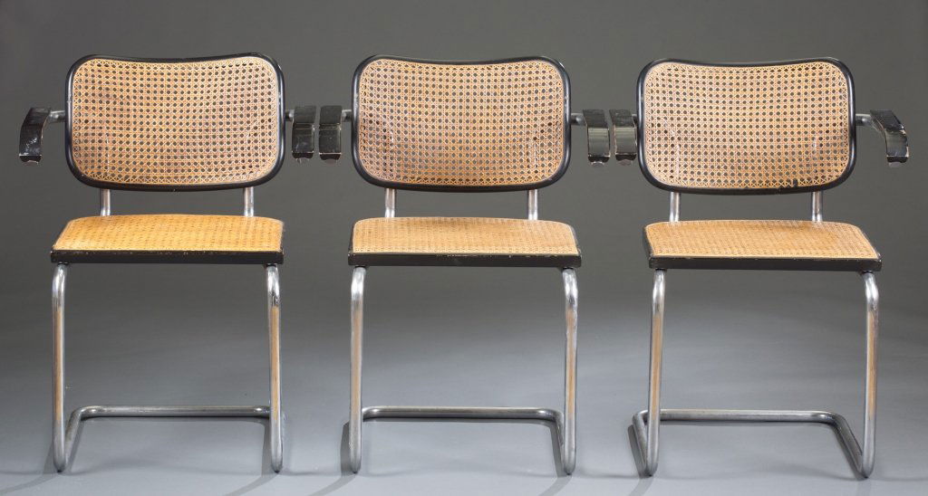 Eight Marcel Breuer Cesca Chairs: Bent tubular steel with caned seat and black lacquer arms. Labeled "Stendig" on underside of seats. 30" H x 23" W x 21 1/2" D