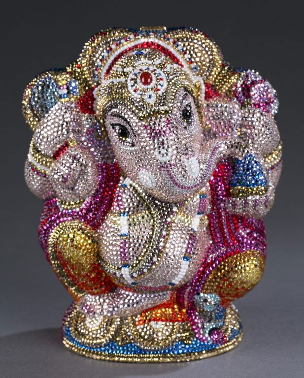 Judith Leiber Crystal Elephant Minaudière: Form of a Hindu Ganesha with brilliant Austrian crystals. Clutch features a gold chain link wrist strap and a top press lock that opens to a gold leather interior. Original price tag of $5,595 attache