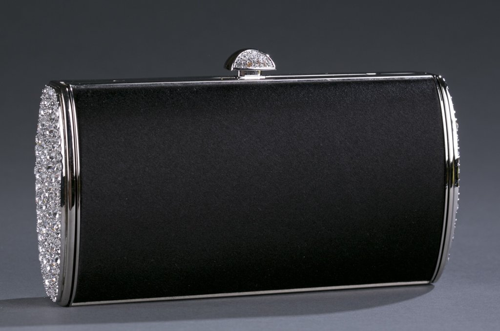 Judith Leiber Black Satin & Crystal Clutch: Crystal studded sides and button top opens to pink satin interior. Compact and change purse included. Interior plaque labeled Judith Lieber and authenticity booklet included. 6 1/2" L