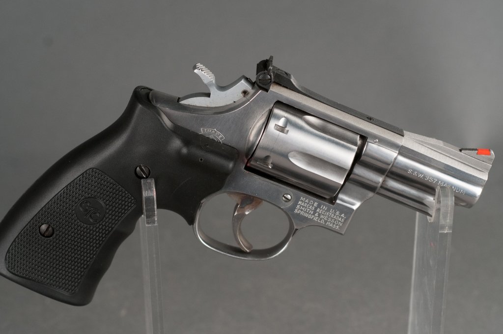 Smith & Wesson .357 Magnum Revolver: Model 66. Serial #13K4025. Overall 98% finish with multiple light scratches. Fitted with new CTC laser-sight grips. Bore is excellent. Includes holster. 2.5" barrel. 8" overall. Provenance: The Estate