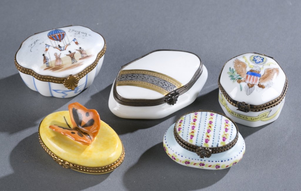 Five Limoges Porcelain Pill Boxes: Includes U.S. Eagle with shield, an air balloon "Bon Voyage", floral blue stripes, a butterfly top and white with gold stripes. Provenance: The Estate of Robert V. Hatcher, Jr. of Manakin-Sabot, VA.