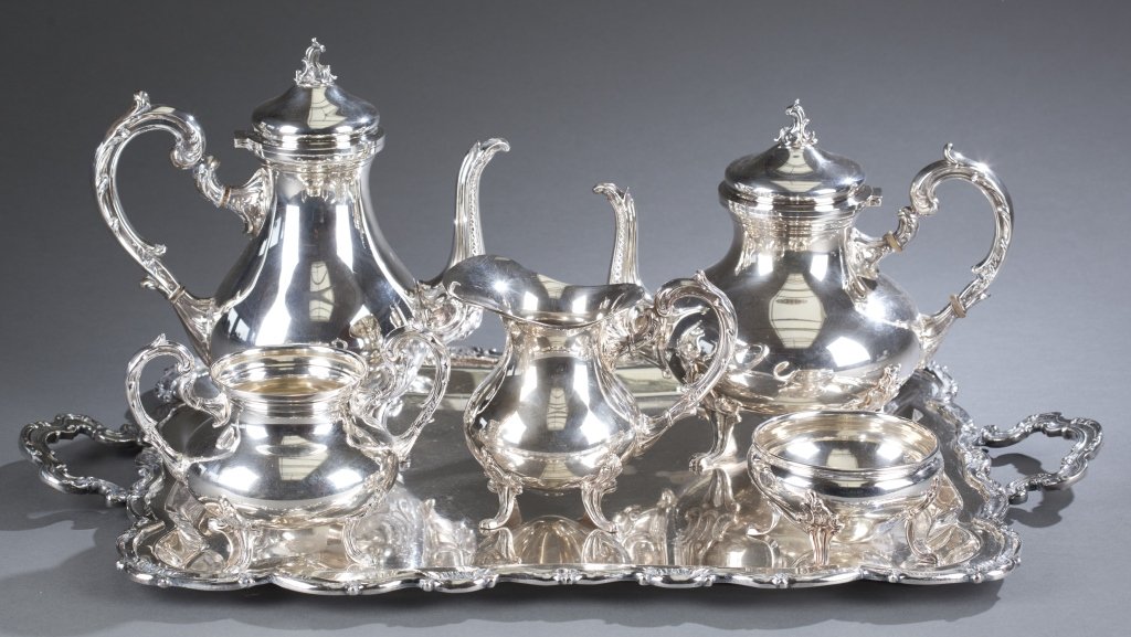 Five-Piece Camusso Peruvian Sterling Coffee Set: Marked on base "Sterling 925/Camusso Made in Peru" Includes: coffee pot, hot water kettle, open creamer, open sugar and waste bowl. Sits on a silver plate tray that is not Camusso. 167.6 ozt