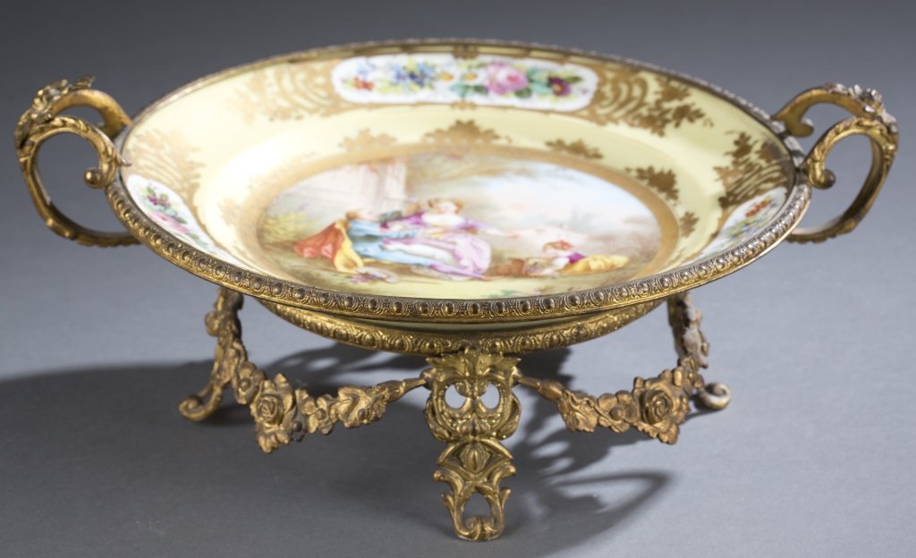 French Sèvres Porcelain & Bronze Tray: French Sèvres Gilt-Bronze Mounted Porcelain Ca. 1753 The round hand-painted tray with yellow borders decorated with floral patterns; The central panel portraying a romantic scene of a young couple an