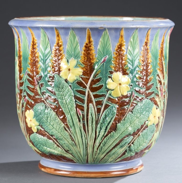 Copeland Majolica: Blue background with alternating brown and green trees with prominent yellow flowers in front. Stamped on underside, "Copeland." 9" H x 9 1/2" D
