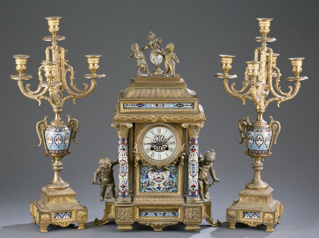 Late 19th c. French Cloisonné Garniture Set: Patinated spelter. Comprised of a clock and two vases en suite. Clock: 21" H x 13 3/4" W x 6 3/4" D Candelabra: 21 3/4" H
