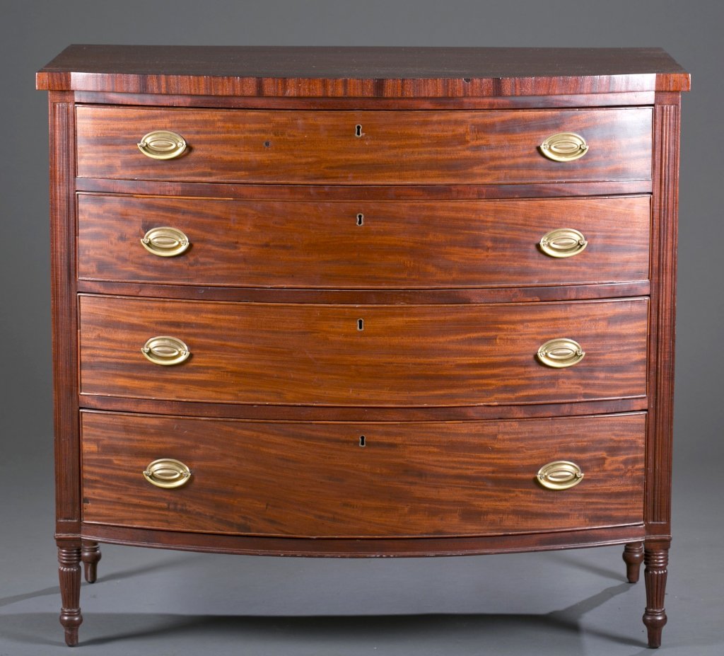 19th c. Sheraton New England Bow Front Dresser: Mahogany. Four graduated cock beaded drawers with fluted column side, rests on turned feet. 38 1/2" H x 42" W x 22 1/2" D