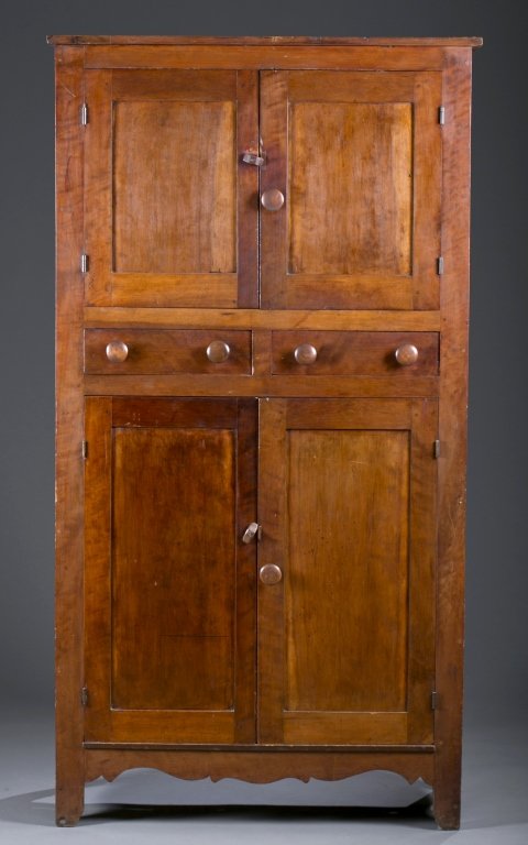 American Country Carved Flat Wall Cupboard: Cherry. Paneled cabinets open to shelved interior, shaped skirt. 72" H x 37" W x 16 1/2" D