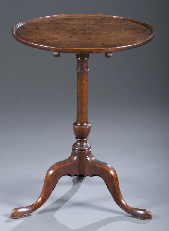 Ca. 1770 English Tea Table: Mahogany with dish top. Slender standard and three splayed legs resting on slipper feet. 27 1/2" H x 21" Dia