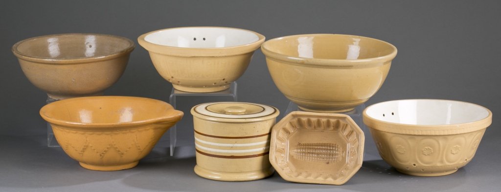 Seven Yellow Ware Dishes: Seven mold decorated Yellow ware dishes include: (1) T.G. Green & Co Ltd. Colander, molded in a scroll and line pattern with a flat beaded rim, glazed in yellow with cream inside, star shaped strainer