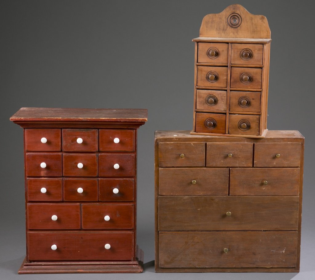 Three Spice Cabinets: Three Spice Cabinets include: (1) Seven-Drawer Hanging Spice Cabinet carved from pine with brass pulls, and a tin sheet back assembled with cut square nails. 18 3/4" H x 19 1/2" L x 4 3/4" W (2) Twelv