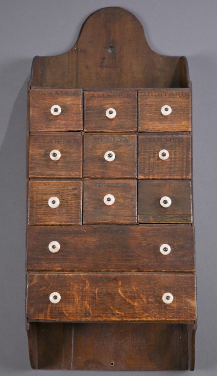 Hanging Spice Cabinet: Eleven drawers with porcelain pulls and original stamped labels. 23 3/4" L x 10" W