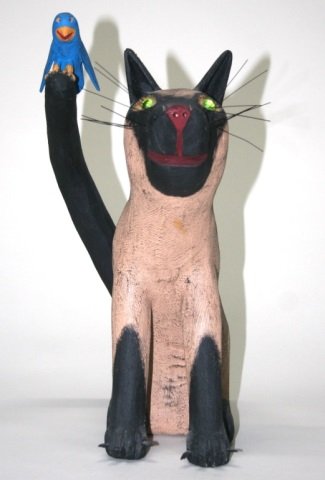 Ron S. Rodriguez Carved Wooden Cat Sculpture.: New Mexican folk art carved wood and polychrome painted cat with a blue bird on his tail sculpture. On bottom, signed Ron S. Rodriguez and dated 5-5-98. 15 1/2"h.