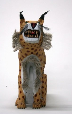 Leroy Archuleta Carved Wooden Leopard Sculpture.: Carved wood and polychrome painted cat with bristles for fur. On bottom, signed Leroy Archuleta and dated 4-7-93. 25 1/21"h x 23'l x 9"w.