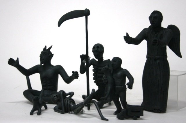 Carlo Mazno Mexican Black Glazed Pottery Figurines: Pictorial scene featuring a young boy and his cat pulling a truck, a playing cat, a seated skeleton holding a cat, a reclining skeleton drinking out of a coconut, the devil and an angel.