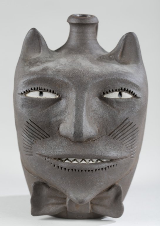 Patrick Eddington (US/Utah, 1953-2016).: Cat Jug with a bow tie molded earthenware. Impressed on back of body, "John Barleycorn / 44 / Eddington." Hairline fracture to side of face from firing. 8 1/4"h.
