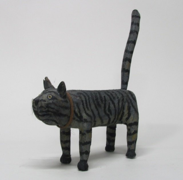 Miguel Rodriguez Carved Wooden Cat Sculpture.: "Seamus the Cat". 1999. New Mexican folk art carved wooden and polychrome painted cat sculpture. On bottom, titled, signed, and dated. 22"h x 18"l x 6"w.