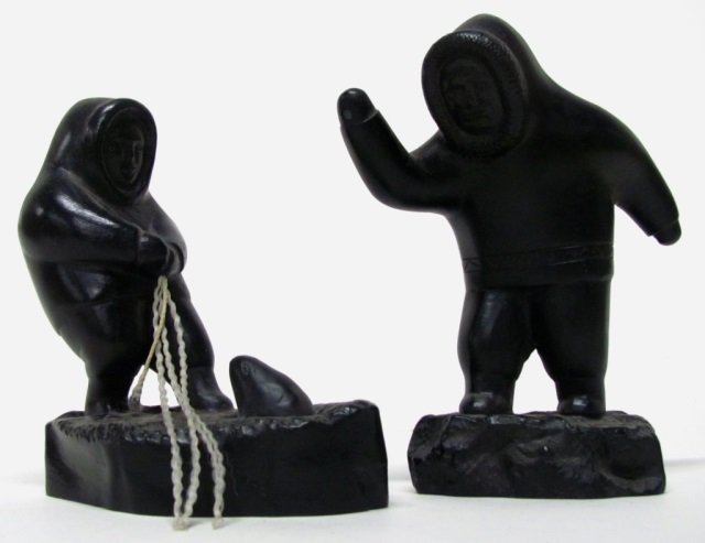 Two Boma Carved Argillite Figures.: Canada. Carved argillite totemic art. Cast resin of a hunter and a seal catcher. Carved, "Boma, Canada" on the side. 6" h. ++ 5 1/4" h. ++