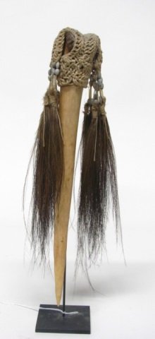 New Guinea Carved Bone Dagger.: Sepik River. Carved Cassowary bone with twine macrame, shells, and feathers. 14"h (not including stand).