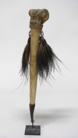 New Guinea Carved Bone Dagger.: Sepik River. Carved Cassowary bone with twine macrame, beads, and feathers; terminating point is a bird beak. 14 1/2"h (not including stand).