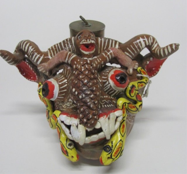 Polychrome El Diablo Mexican Folk Art Mask.: Polychrome painted clay El Diablo mask with man and snakes. No marks or signature. 7 1/4"hx 9 1/2"w x 3 3/8"d.