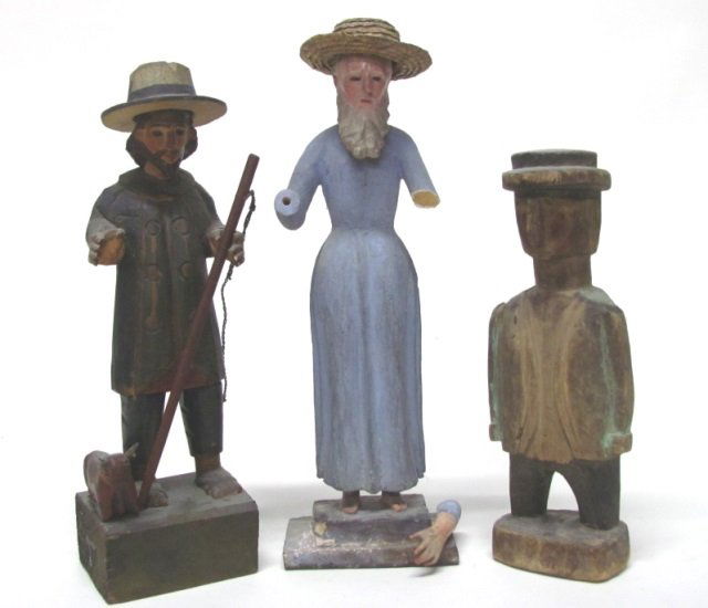 Three Mexican Folk Art Carved Figures.: Shepherd figure. Polychrome painted carved wood. Unmarked. 13 3/4" h. ++ Moses/Shepherd hatted figure. Polychrome painted carved wood with woven straw hat. Unmarked. 14" h. Broken arms. ++ Polychrome