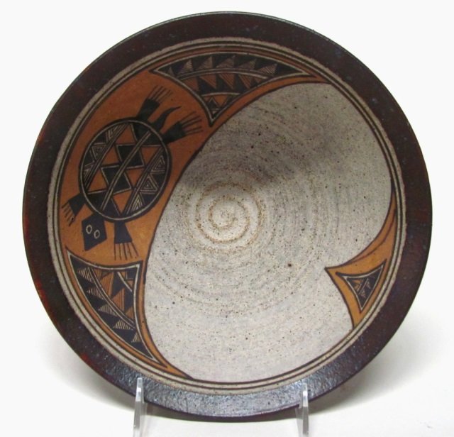 Polychrome Native American Shallow Bowl.: Decorated with turtle and geometric designs on interior with deep terra cotta red glazed exterior. On bottom, faint impressed mark inside a square. 3 3/4"h x 9 1/4"diam.