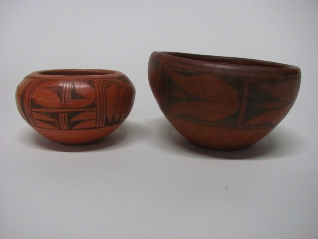 Pair of Native American Red & Black Bowls.: Red clay bowl decorated with traditional geometric designs in black. Initialed on interior, " M.C. P." 3 7/8" h x 6 3/8" diam. ++ Hopi bowl with traditional designs in black. 3" h x 5 1/8" diam.