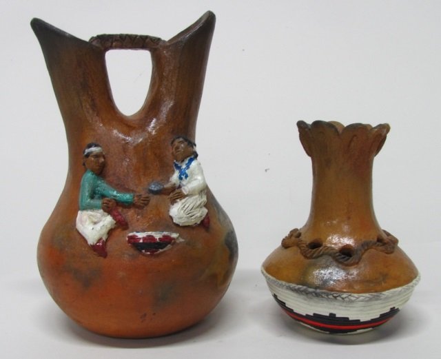 Silas & Bertha Claw (US/Navajo Nation, 20th c.).: A two spout clay wedding vase with a traditional domestic scene sculpted applique with oil paint and varnish. Signed on base. 10" h. ++ A clay vase with traditional basket design. Oil paint and varnis