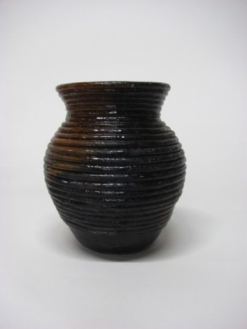 Louise R. Goodman (US/Navajo Nation, b. 1937).: Exterior coil brown and black clay pot with pinon pitch. Incised initials on bottom. 10 1/8" h.