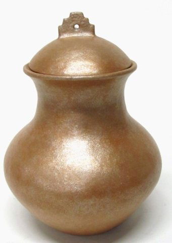 Anthony Durand (Picuris Pueblo, NM, b. 1956).: Tan and black body with micaceous luster over-glaze and rounded mouth. Lidded clay jar with traditional finial. On bottom, incised initials, "A.D., Picuris." 11 1/2" h x 9" diam. Featured in, "Trading