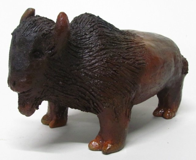 Louise R. Goodman (US/Navajo Nation, b. 1937).: Buffalo clay sculpture with pinon pitch. Incised initials on base. 6 1/4" h x 11 1/2" l x 5 1/4" w.