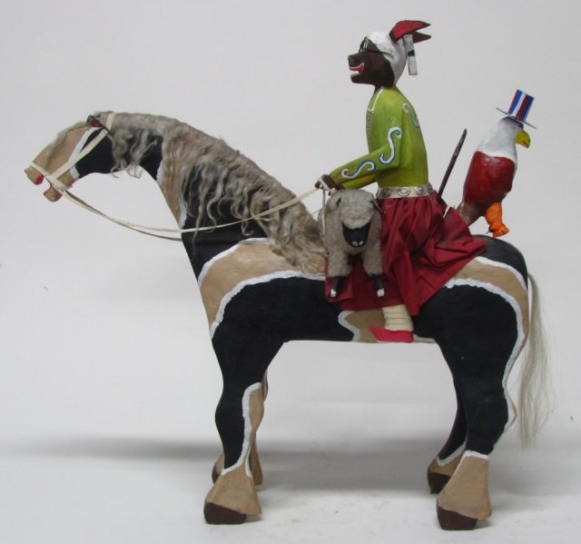 Delbert Buck (New Mexico/Navajo, b. 1946).: Woman Rabbit Riding Horse with Bald Eagle wearing an American Flag Top Hat and a sheep. Polychrome paint on carved wood. 32" h x 32" l x 10 1/4" w. Repairs to rabbit's ears.