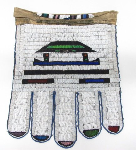 Beaded Wedding Apron, Ndebele, South Africa, pre-1950.: Having five bottom flaps, woven in geometric patterns with black, blue, red,and green beads on a white beaded ground on leather hide. 24" l x 18" w.