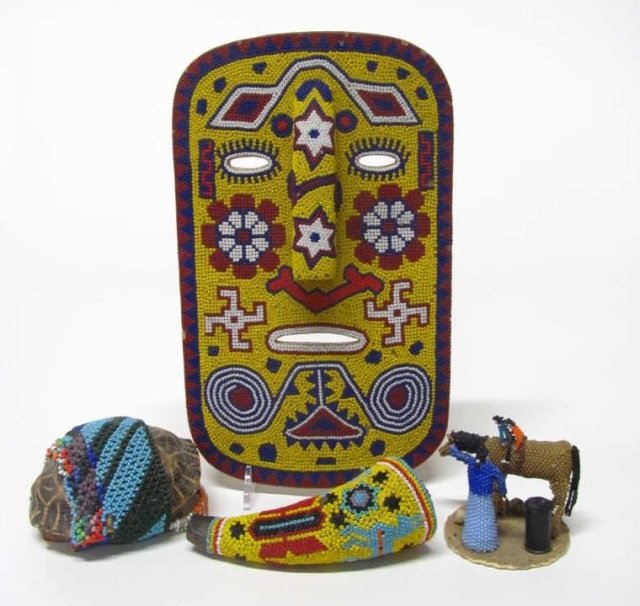 Four Native American Beadwork Items.: Carved mask with polychrome beadwork. 10 1/4" l x 6 1/2" w. ++ Powder horn with polychrome beadwork. Missing stopper. 4 1/4" l. Turtle Shell beadwork rattle. Missing handle and beads. 6 1/2" l. ++ Bea
