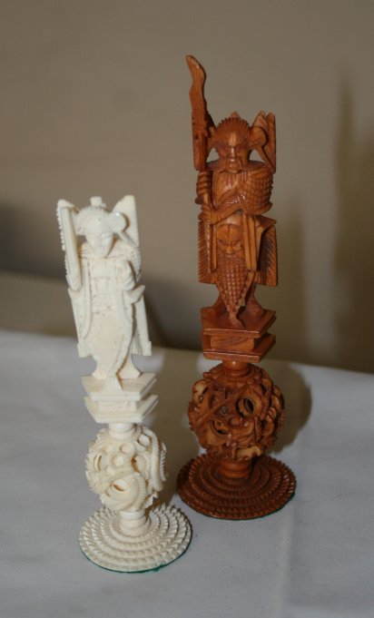 Chinese Carved Ivory Chess Set,: each piece carved and with a figural surmount and a puzzle ball terminal all encased in later chess top box