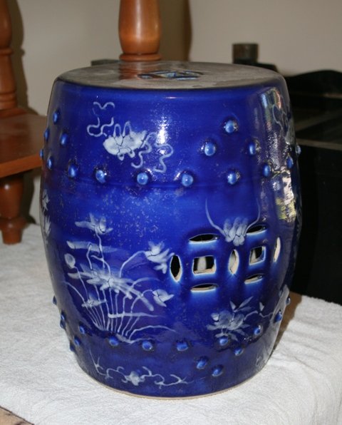 Chinese Blue and White Tambourette,: modelled in typical form , with flared sides with strong blue ground with white highlights in the form of floral sprays and Buddhist motifs height 33cm