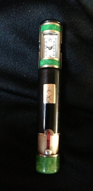A Cartier Enamel Combination Watch and Lipstick Case, c: modelled in tubular form, with green and black enamel tonal body l 7.75cm ,Private Collection Blakehurst ,Sydney