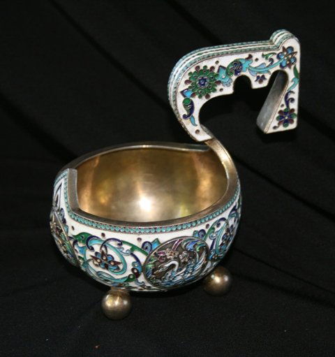 A Russian Silver Gilt and Enamel Kovsh ,: Bearing the Marks of Gustav Klingert, modelled with three roundels with figures of swans amid lavish tracing foliage on a white ground