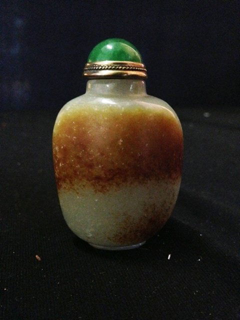A Chinese Celadon Jade Snuff Bottle ,: modelled in slightly tapered form and showing traces of skin , h 6cm