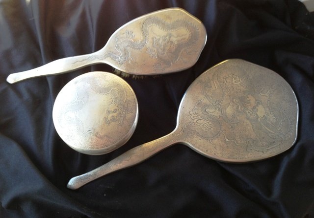 A Three Piece Chinese Silver Export Dressing Table Set,: comprising brush mirror and box and cover(3)