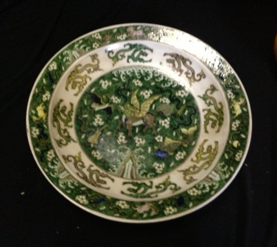A Chinese Famille Vert Charger ,Possibly Republic: centered with a variety of mythical animals , amid cloud scrolls and fans, , surrounded by sprays of foliate tracery , and a solid band of horses and buddhist motifs amid further cloud scrolls , six c