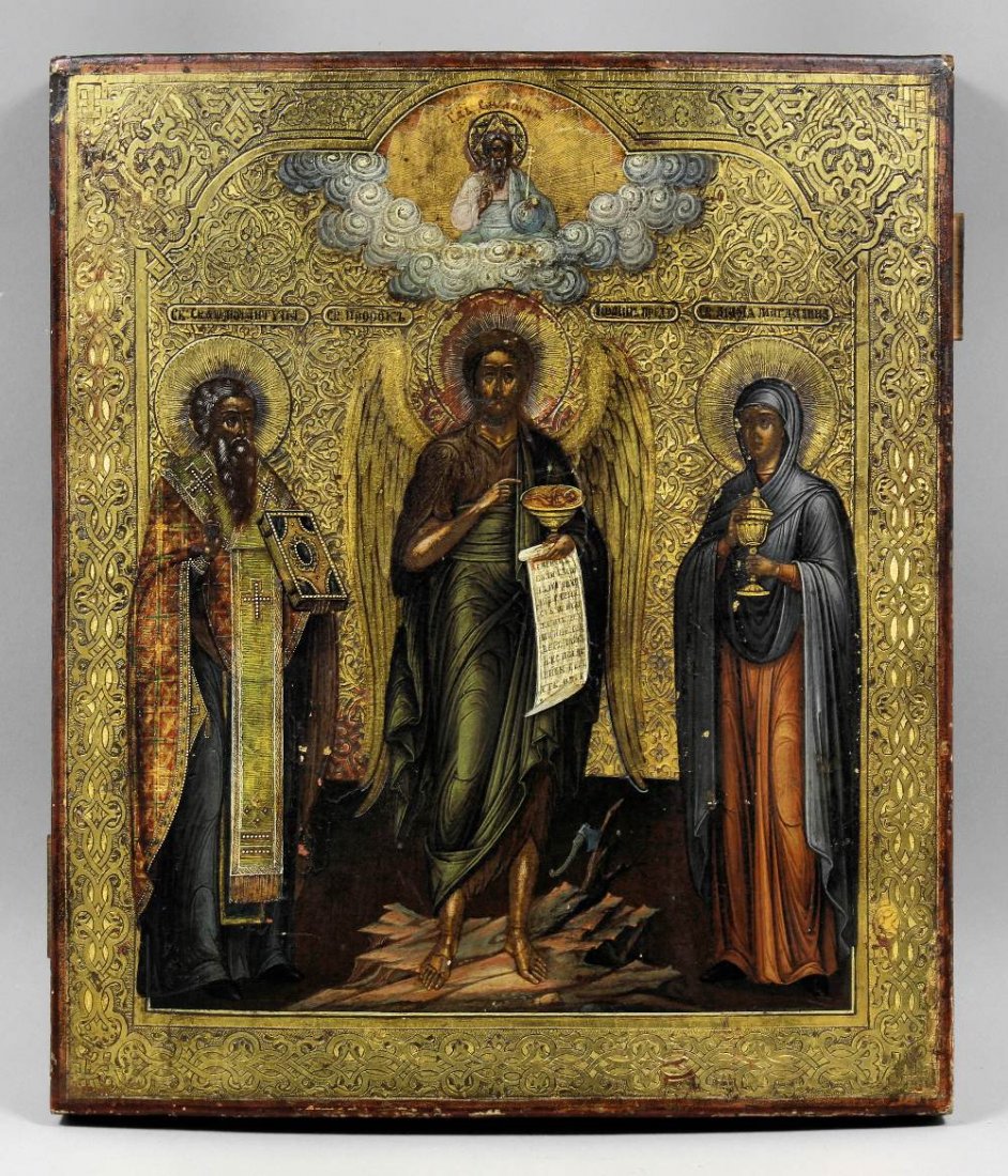 A 19th Century Russian icon of St. John The Baptist hol: A 19th Century Russian icon of St. John The Baptist holding a chalice containing Christ Emmanuel flanked by Sts. Antipas and Mary Magdalene, 12.25ins x 10.5ins