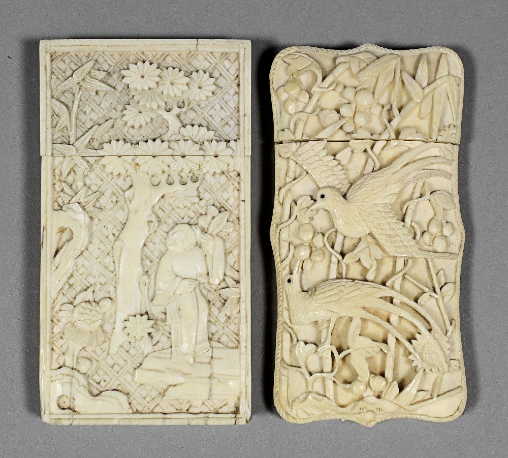 A Chinese ivory card case of shaped outline, deeply car: A Chinese ivory card case of shaped outline, deeply carved with birds in branches, 3.5ins (89mm) x 1.87ins (48mm), and one other, 3.375ins (86mm) x 1.87ins (48mm)